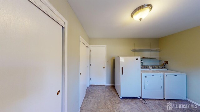 clothes washing area with washing machine and clothes dryer