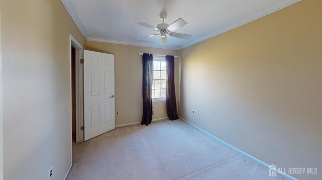 unfurnished bedroom with ceiling fan, ornamental molding, and light colored carpet