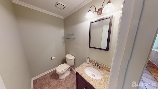 bathroom with toilet, vanity, and crown molding