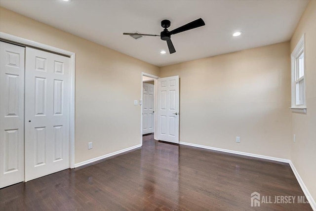 unfurnished bedroom featuring baseboards, recessed lighting, wood finished floors, a closet, and a ceiling fan