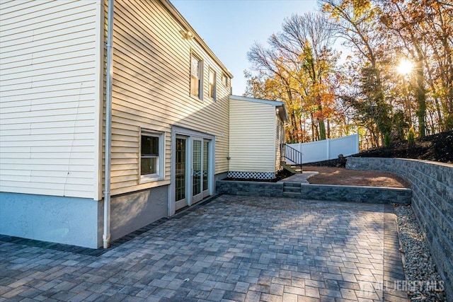 view of side of home featuring a patio and fence