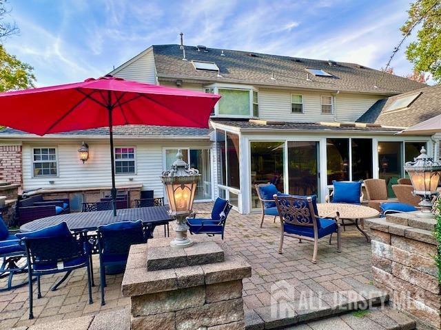 rear view of property featuring a patio area