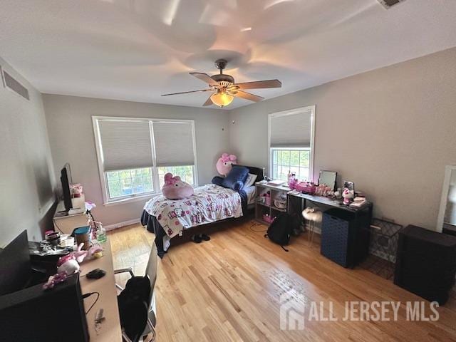 bedroom with ceiling fan and wood-type flooring