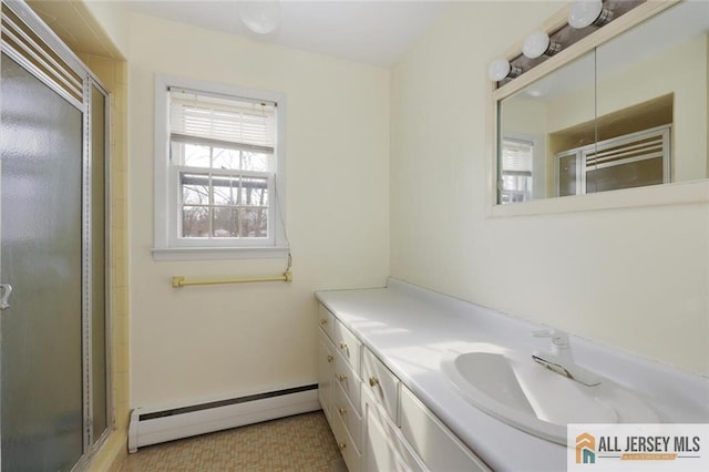 full bathroom with vanity, baseboard heating, and a shower stall