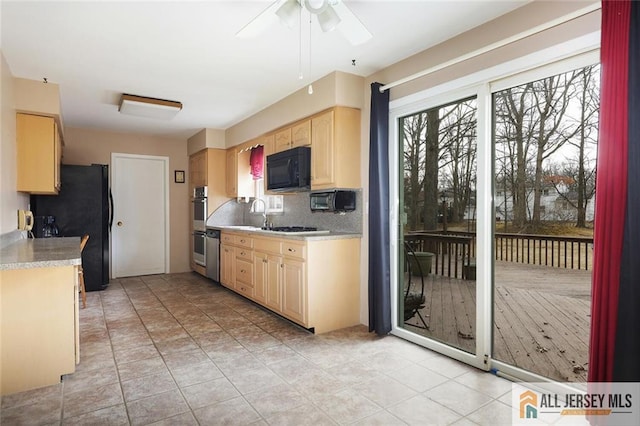 kitchen featuring black appliances, light brown cabinets, backsplash, light countertops, and ceiling fan