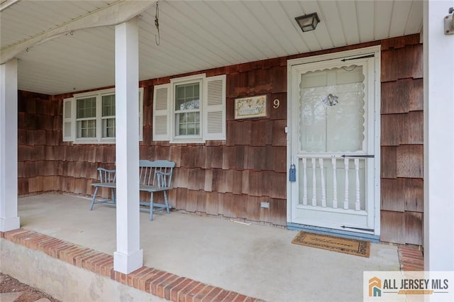 view of exterior entry featuring a porch