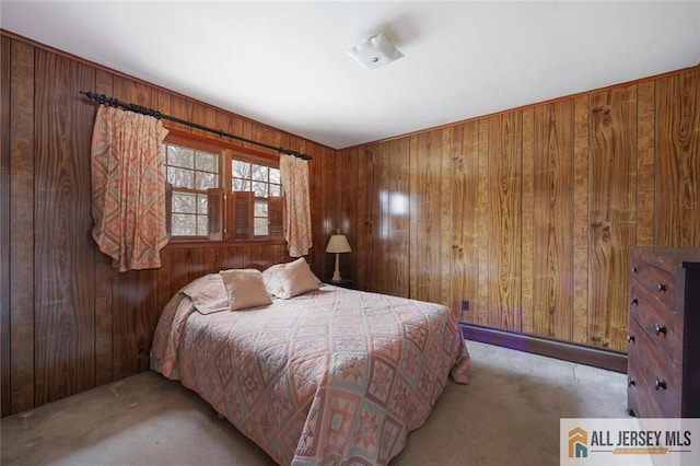 bedroom featuring wood walls and carpet