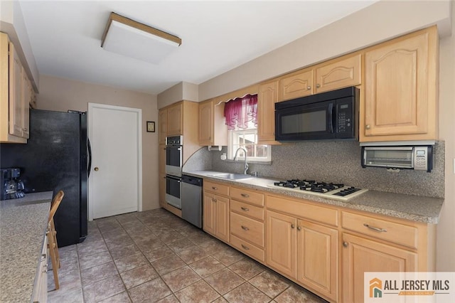 kitchen featuring black appliances, backsplash, light brown cabinetry, and a sink