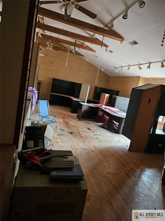 miscellaneous room with ceiling fan, hardwood / wood-style floors, and vaulted ceiling with beams