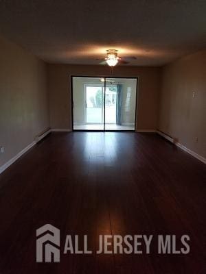 unfurnished room with ceiling fan and dark hardwood / wood-style floors