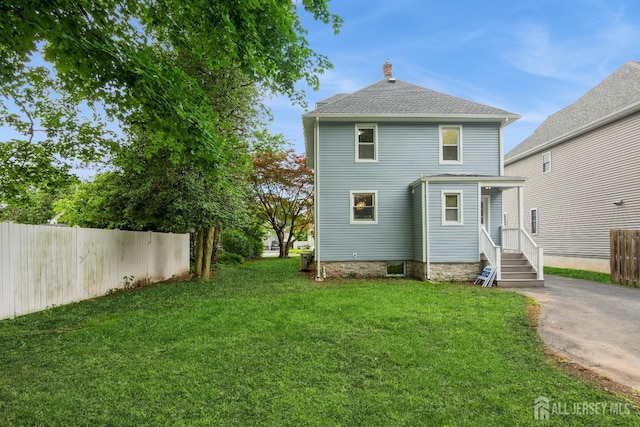 345 1st St, Dunellen, NJ 08812 - back of property featuring a chimney and roof with shingles