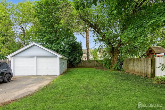 345 1st St, Dunellen, NJ 08812 - view of yard featuring an outdoor structure and a garage