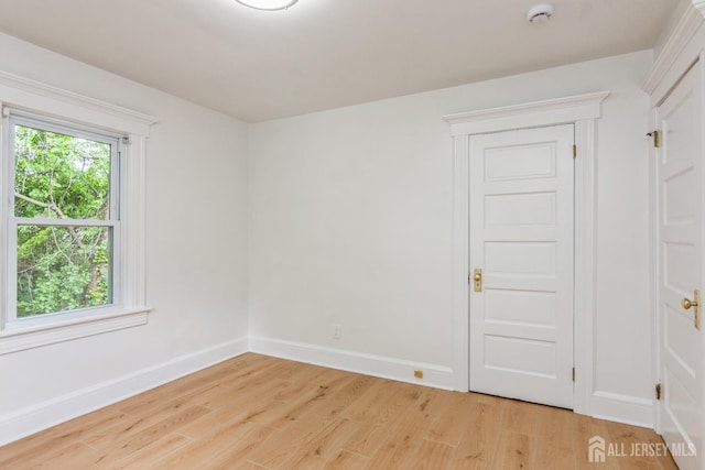 345 1st St, Dunellen, NJ 08812 - empty room featuring light wood-style floors, a smoke detector, and baseboards
