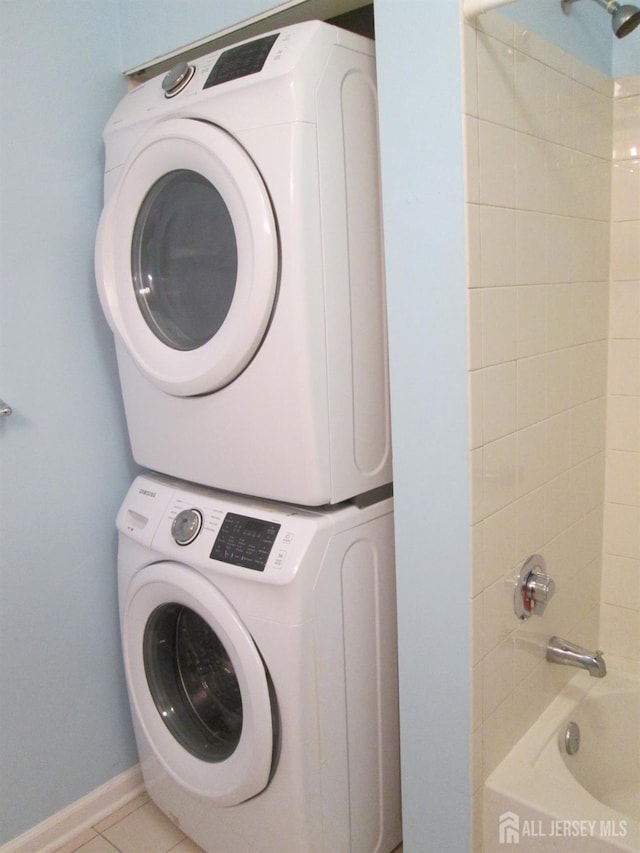 101 Liddle Ave, Edison, NJ 08837 - laundry room featuring estacked washer and dryer and tile patterned floors