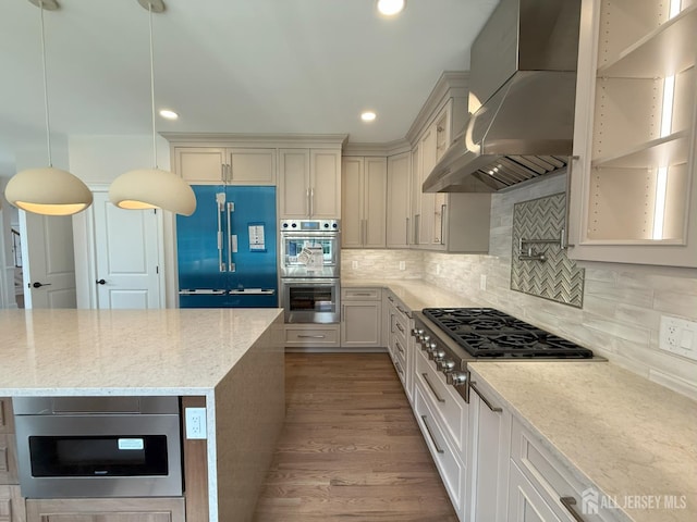 2 Joye Ln, South Brunswick, NJ 08852 - kitchen with stainless steel appliances, wall chimney exhaust hood, light stone countertops, decorative backsplash, and wood finished floors