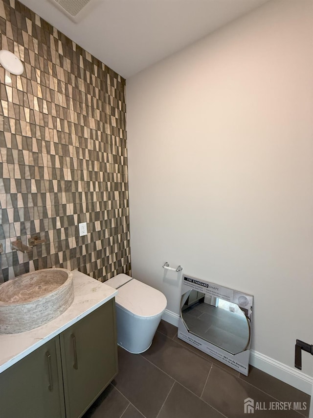 2 Joye Ln, South Brunswick, NJ 08852 - half bathroom with an accent wall, heating unit, tile patterned floors, vanity, and tile walls