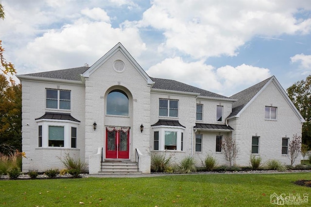 2 Joye Ln, South Brunswick, NJ 08852 - view of front of home with entry steps, brick siding, a front yard, and a standing seam roof
