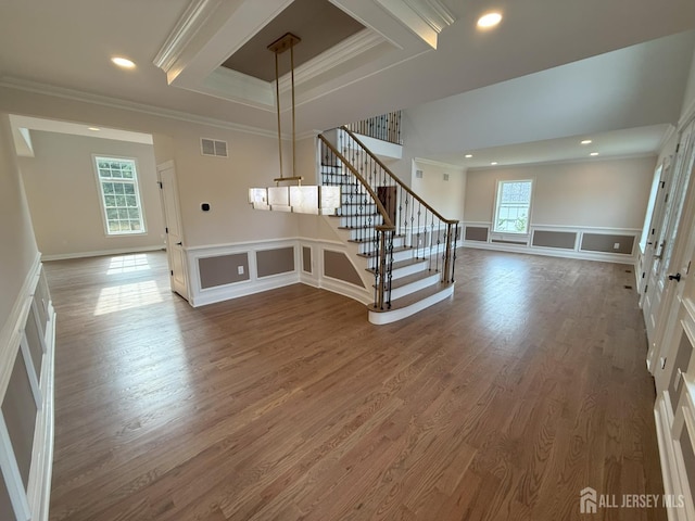 2 Joye Ln, South Brunswick, NJ 08852 - unfurnished living room with ornamental molding, stairway, wood finished floors, a decorative wall, and wainscoting