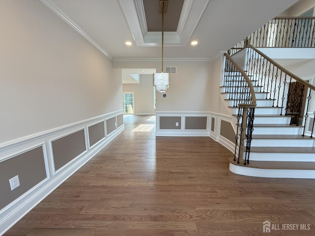 2 Joye Ln, South Brunswick, NJ 08852 - stairway with crown molding, wood finished floors, a decorative wall, recessed lighting, and a tray ceiling