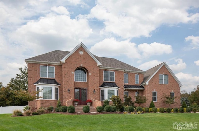 2 Joye Ln, South Brunswick, NJ 08852 - view of front facade with brick siding, a standing seam roof, and french doors