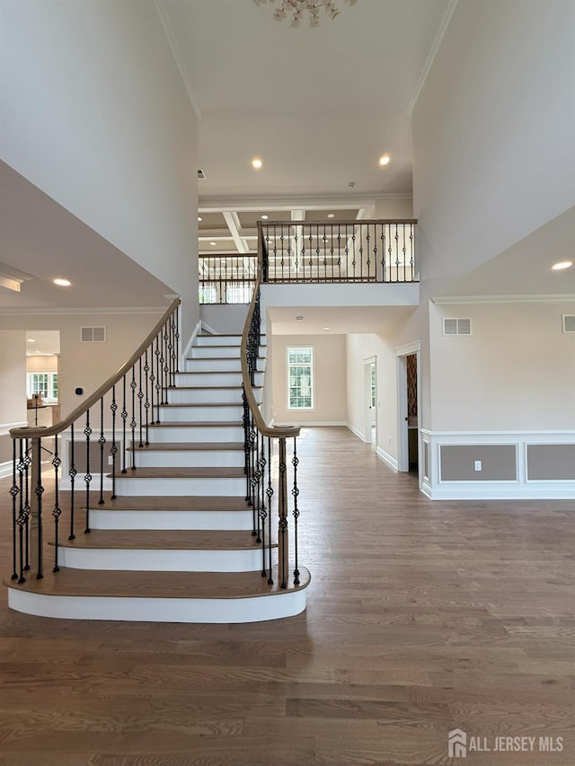 2 Joye Ln, South Brunswick, NJ 08852 - staircase featuring crown molding, plenty of natural light, a towering ceiling, wood finished floors, and recessed lighting