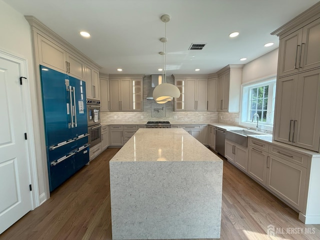 2 Joye Ln, South Brunswick, NJ 08852 - kitchen with appliances with stainless steel finishes, a center island, extractor fan, tasteful backsplash, and light stone counters