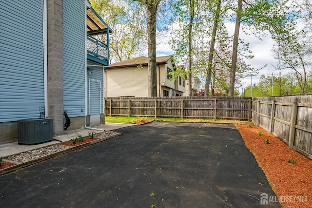 exterior space with a fenced backyard and central AC