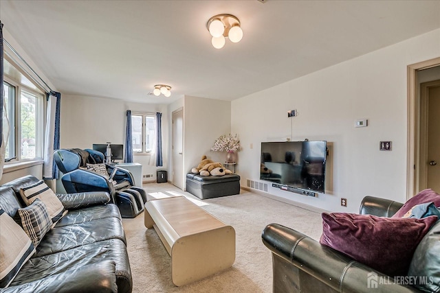 living area featuring light colored carpet and visible vents
