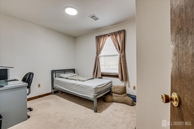 carpeted bedroom with baseboards and visible vents