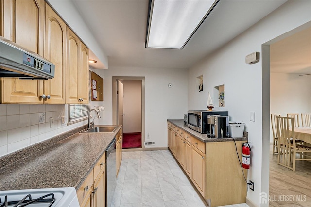 kitchen featuring decorative backsplash, visible vents, appliances with stainless steel finishes, a sink, and extractor fan