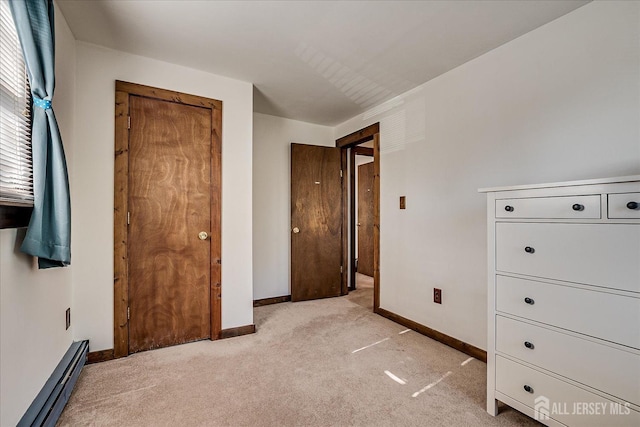 unfurnished bedroom with baseboards, baseboard heating, and light colored carpet