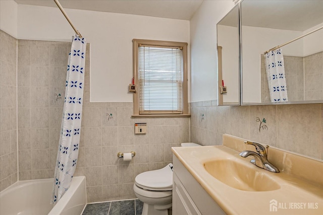 bathroom with tile walls, tile patterned flooring, vanity, toilet, and shower / tub combo with curtain
