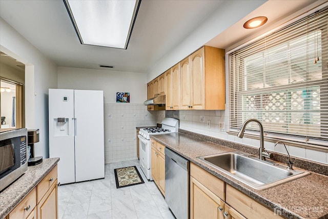 kitchen featuring visible vents, stainless steel appliances, a sink, light brown cabinets, and under cabinet range hood