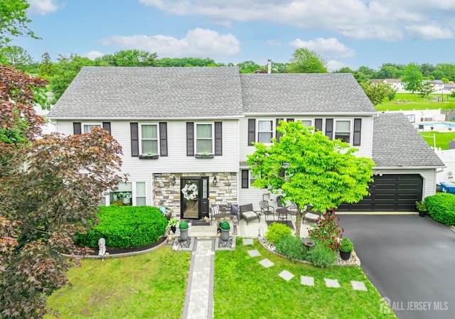 24 Higgins Rd, Old Bridge, NJ 08857 - view of front facade featuring a front yard, roof with shingles, and driveway