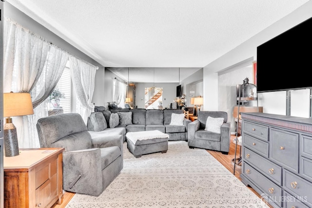 24 Higgins Rd, Old Bridge, NJ 08857 - living area with light wood-style floors and a textured ceiling