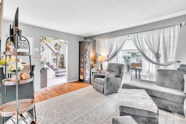 24 Higgins Rd, Old Bridge, NJ 08857 - living room featuring stairs, wood finished floors, a textured ceiling, and baseboards