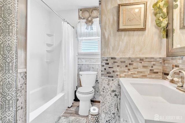 24 Higgins Rd, Old Bridge, NJ 08857 - full bathroom with toilet, vanity, tile walls, shower / tub combo, and wainscoting