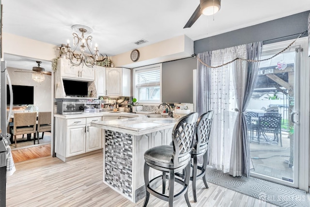 24 Higgins Rd, Old Bridge, NJ 08857 - kitchen with a ceiling fan, light countertops, a sink, a peninsula, and a breakfast bar