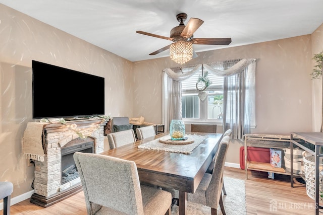 24 Higgins Rd, Old Bridge, NJ 08857 - dining space with ceiling fan, wood finished floors, a fireplace, and baseboards