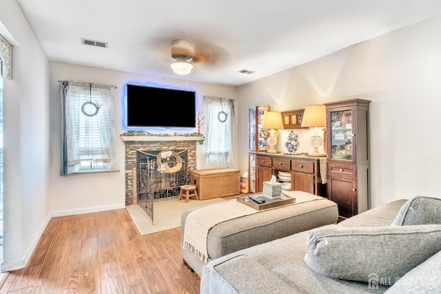 24 Higgins Rd, Old Bridge, NJ 08857 - living room with a stone fireplace, wood finished floors, and baseboards