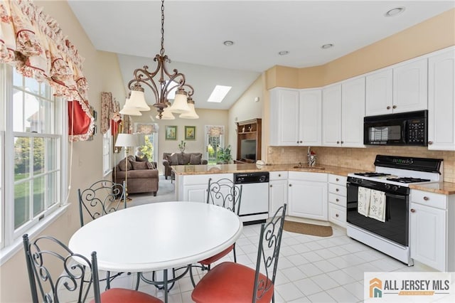 12 Wellfleet St, Monroe, NJ 08831 - kitchen featuring range with gas stovetop, white dishwasher, black microwave, decorative backsplash, and lofted ceiling