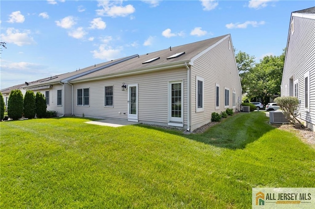 12 Wellfleet St, Monroe, NJ 08831 - back of property with a lawn, cooling unit, and a patio