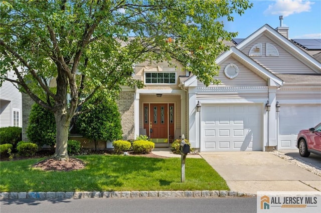 12 Wellfleet St, Monroe, NJ 08831 - view of front of home with concrete driveway, an attached garage, and a front yard