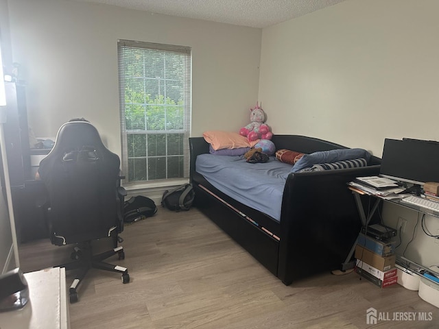 167 Rachel Ct, Franklin Twsp, NJ 08823 - bedroom with light wood-style floors, a desk, and a textured ceiling