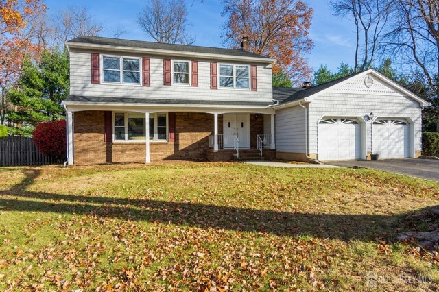 front facade with a garage and a front yard