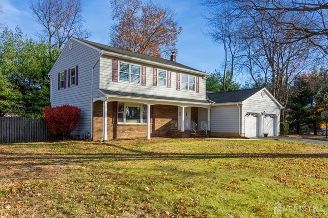 view of front of home featuring a garage and a front lawn