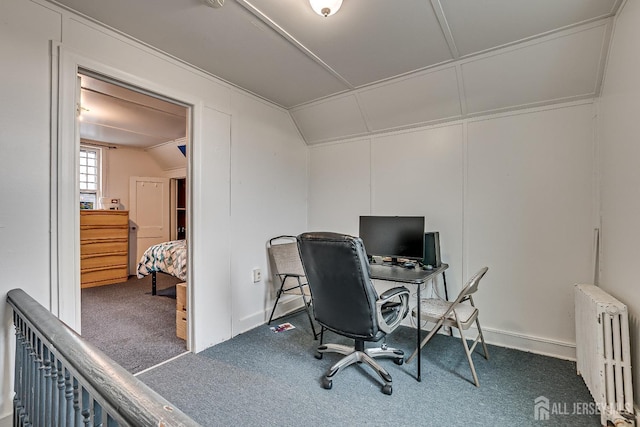 office space with radiator, vaulted ceiling, and carpet