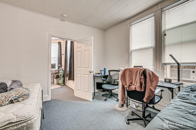 carpeted bedroom featuring multiple windows and cooling unit