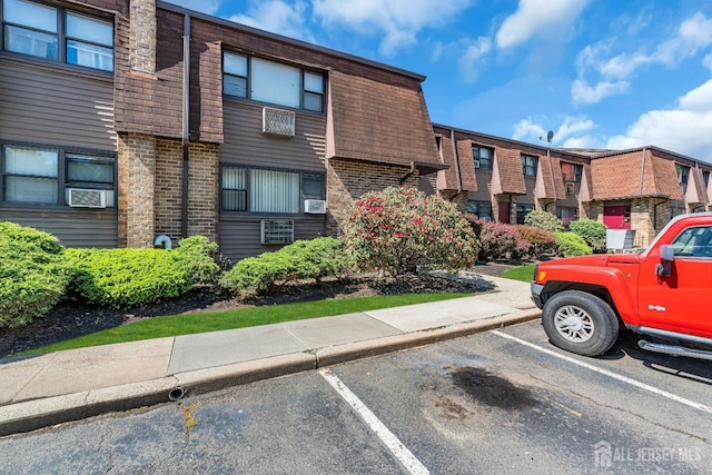 1133 Livingston Ave Unit 11C, North Brunswick, NJ 08902 - view of building exterior with uncovered parking and a residential view