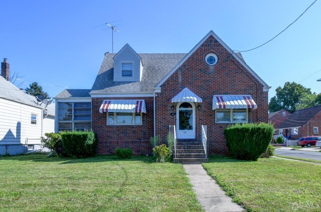 bungalow-style house with a front yard